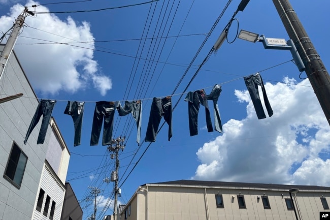 Pairs of jeans flap over Jeans Street in Kojima, Okayama prefecture, Japan, on Sept. 4, 2024. (AP Photo/Yuri Kageyama)