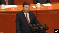 Chinese President Xi Jinping speaks during a ceremony to commemorate the 90th anniversary of the founding of the People's Liberation Army at the Great Hall of the People in Beijing, Tuesday, Aug. 1, 2017. (AP Photo/Andy Wong, Pool)