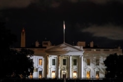 The White House is lit before dawn after U.S. President Donald Trump announced that he and U.S. first lady Melania Trump have both tested positive for the coronavirus disease, in Washington, Oct. 2, 2020.