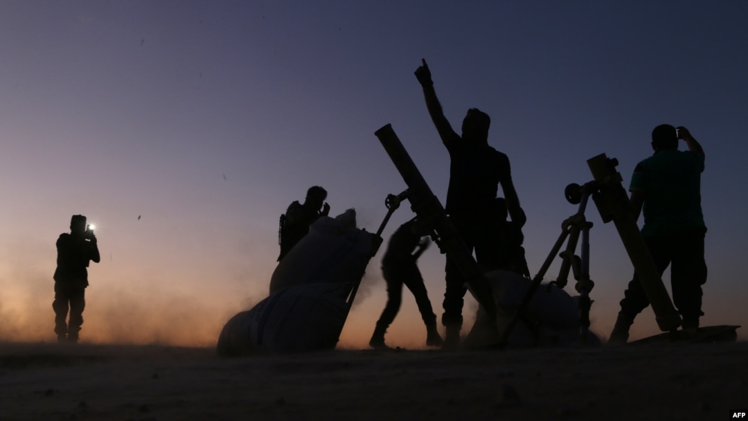 Fighters from the Free Syrian Army cheer and react as they fight against Islamic State group jihadists on the outskirts of the northern Syrian town of Dabiq, Oct. 15, 2016.