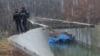 Police officers patrol near the damaged canal near Zubin Potok, Kosovo, Nov. 30, 2024.