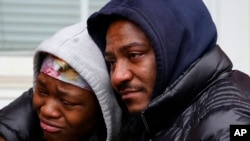People gather near the scene of a deadly row house fire, Jan. 5, 2022, in the Fairmount neighborhood of Philadelphia. 