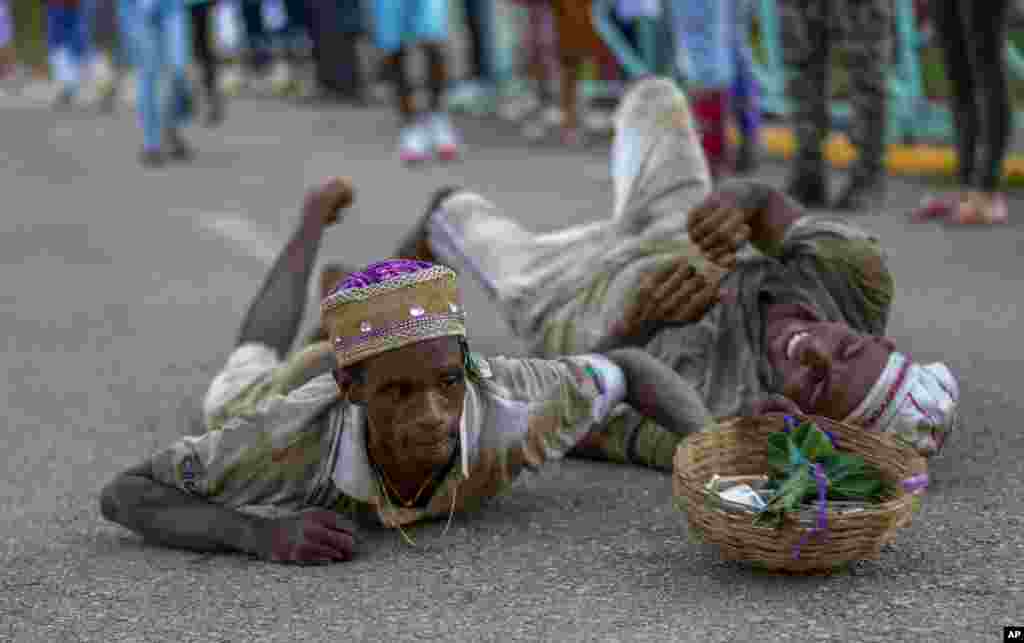 Followers of Saint Lazarus, known as the protector of the sick, crawl in self-imposed penance during a pilgrimage to the saint's shrine for his annual feast day, in Santiago de Las Vegas, Cuba, Dec. 16, 2024.