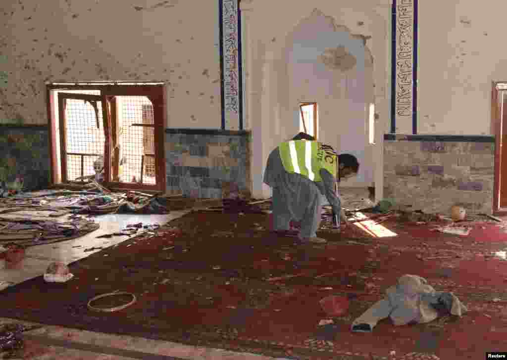 A rescue worker collects evidence after an explosion in a Shi&#39;ite mosque in Shikarpur, located in Sindh province, Pakistan, Jan. 30, 2015.