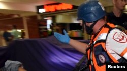 An injured man receives treatment at the Beersheba central bus station, where a Palestinian gunman went on a stabbing and shooting rampage, October 18, 2015.