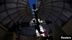 Devendran, a 55-year-old observer, positions the six-inch telescope at the Kodaikanal Solar Observatory, India, Feb. 6, 2017. 