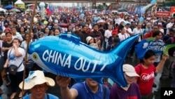 Protesters display a balloon with an anti-China message during a rally near the Philippine Congress to protest the 4th State of the Nation (SONA) address by President Rodrigo Duterte Monday, July 22, 2019 in suburban Quezon city, northeast of Manila.