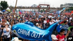 Protesters display a balloon with an anti-China message during a rally near the Philippine Congress to protest the 4th State of the Nation (SONA) address by President Rodrigo Duterte Monday, July 22, 2019.