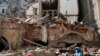 Citizens ride their scooters and motorcycles by a house that was destroyed in Tuesday's massive explosion in the seaport of Beirut, Lebanon, Aug. 5, 2020. 