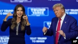 FILE - President-elect Donald Trump, right, and South Dakota Governor Kristi Noem dance to the song "YMCA" during a campaign town hall in Oaks, Pennsylvania, Oct. 14, 2024. Videos of Trump dancing to the song have brought Trump to a new height of fame on Chinese social media.