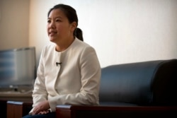FILE - Xu Yan, the wife of Chinese lawyer Yu Wensheng, speaks during an interview in their apartment on the outskirts of Beijing, Jan. 19, 2018.
