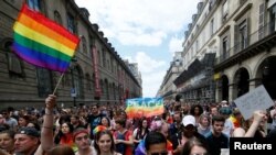 Participants take part in the annual Gay Pride parade in Paris, France June 24, 2017.