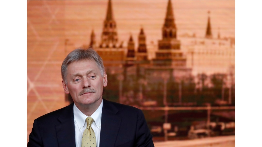 FILE - Kremlin spokesman Dmitry Peskov listens during a news conference in Moscow, Russia, Dec. 19, 2019.