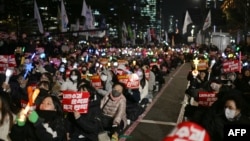 Demonstrators take part in a sit-in protest calling for the ouster of South Korea President Yoon Suk Yeol on the grounds of the National Assembly in Seoul on December 9, 2024.