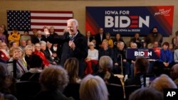 Democratic presidential candidate former Vice President Joe Biden speaks to local residents during a bus tour stop, Dec. 3, 2019, in Mason City, Iowa.