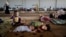 FILE - Syrian refugee children rest at a camp near the Turkish border. 