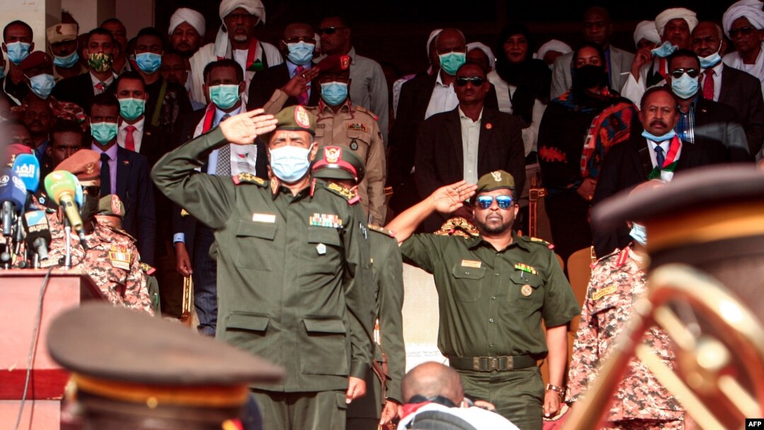 Chairman of Sudan's Sovereignty Council General Abdel Fattah al-Burhan performs a military salute during a reception ceremony upon the arrival of the government negotiating team from Juba, in the capital Khartoum, Oct. 8, 2020.