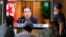 People watch a TV screen showing North Korean leader Kim Jong Un in a news program, at Seoul Railway Station in Seoul, South Korea, Sept. 30, 2021.
