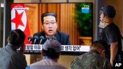 People watch a TV screen showing North Korean leader Kim Jong Un in a news program, at Seoul Railway Station in Seoul, South Korea, Sept. 30, 2021.