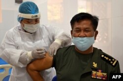 A three star general receives the Sinopharm vaccine from China during the first day of COVID-19 vaccinations at a hospital in Phnom Penh, Feb. 10, 2021.