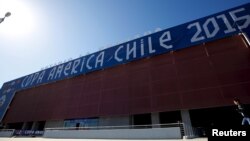 A man runs in front of the entrance of the La Portada stadium in La Serena, one of the venues where the Copa America Chile 2015 Group B soccer matches will be held, June 11, 2015. 