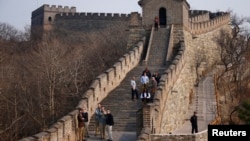 FILE - Visitors walk near a section of the Great Wall of China, north of Beijing, October 28, 2006. (REUTERS/Jason Lee)