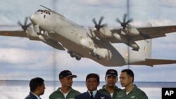 Indian Air Force personnel attend the induction of the C-130J-30 Super Hercules Aircraft during a ceremony at Hindan Air Force Station in Uttar Pradesh, Feb 5 2011