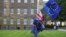 An anti-Brexit protester carries flags opposite the Houses of Parliament in London, Britain, May 10, 2018. 