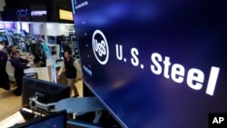 FILE - The logo for U.S. Steel appears on a screen above the trading floor of the New York Stock Exchange.