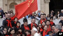 FILE - Pope Francis meets a group of faithful from China at the end of his weekly general audience in St. Peter's Square, at the Vatican, April 18, 2018.