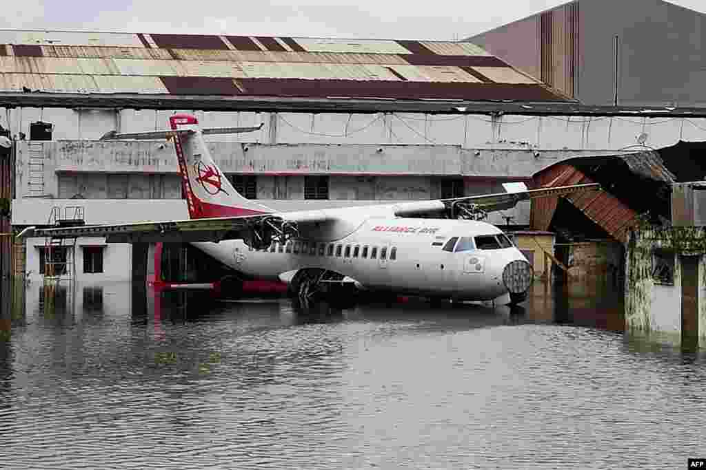 An aircraft is parked at the flooded Netaji Subhas Chandra Bose International Airport after the landfall of cyclone Amphan in Kolkata, India.