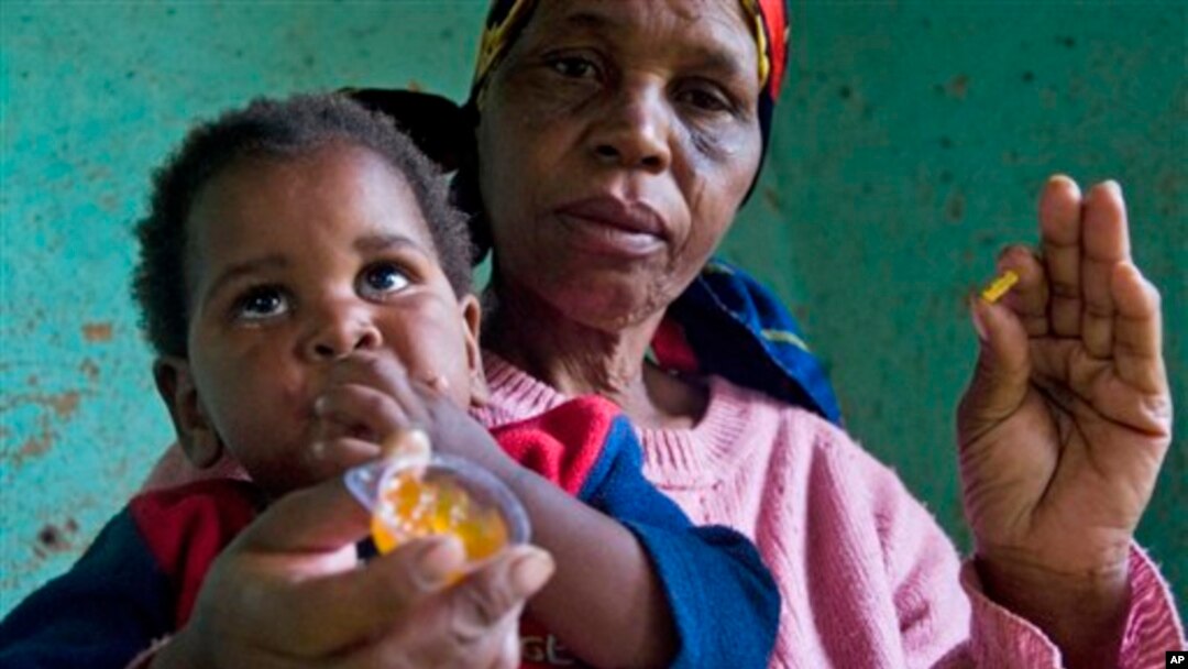 HIV positive child, Gift is given some jam prior to her ARV medication by a carer Tuesday Nov. 30, 2010 near Durban South Africa. (AP Photo/John Robinson)