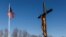(FILE) A Crucifix and an American flag stand at St Mary's Church in Champlain, New York, U.S., January 22, 2025.