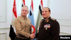 FILE - Egypt's Chief of Staff of the Armed Forces Sami Anan, right, shakes hands with the U.S. Commander of the Central Command James Mattis during a meeting in Cairo, Egypt, March 29, 2011. Anan announced his candidacy for president of Egypt on Saturday.