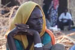 Ouatash Mesafin and her husband wait out the war, grateful to at least have their children and grandchildren with them in the Um Rakouba camp in Sudan. (Mohaned Bilal/VOA)