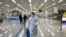 State Commission of Quality Management staff member in protective gear carries a disinfectant spray can as they continue to check the health of travelers and inspect and quarantine goods at the Pyongyang Airport in Pyongyang, North Korea, Feb. 1, 2020.