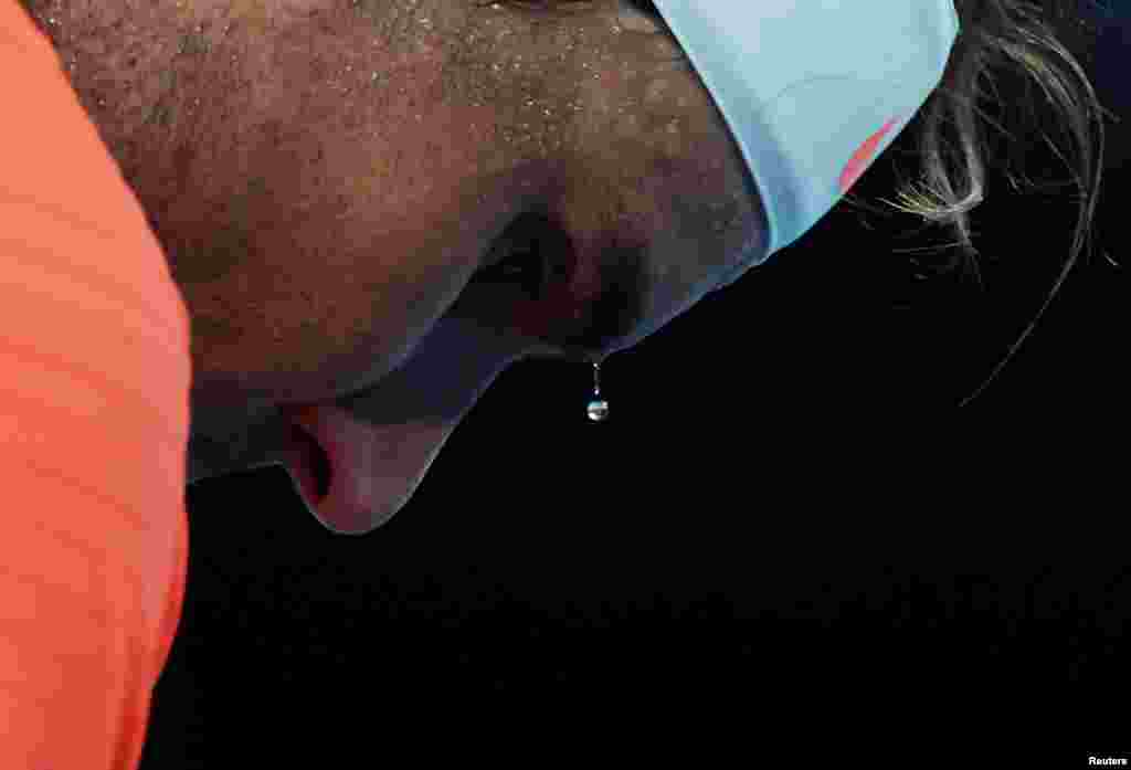A bead of sweat drips from Spain&#39;s Rafael Nadal during his second round match against Michael Mmoh of the U.S. at the Australian Open tennis championship in Melbourne.
