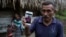 Domingo Caal Chub, 61, holds a smartphone displaying a photo of his granddaughter, Jakelin Caal Maquin, in Raxruha, Guatemala, Dec. 15, 2018. The 7-year-old girl died in a Texas hospital, two days after being taken into custody by U.S. Border Patrol agent