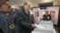 A man casts his ballot paper at a polling station in the town of Khimki outside Moscow, Russia, October 14, 2012. 
