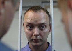 Ivan Safronov stands inside a defendants' cage before a court hearing in Moscow, Russia, July 7, 2020.
