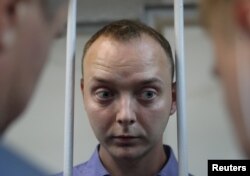 Ivan Safronov stands inside a defendants' cage before a court hearing in Moscow, Russia, July 7, 2020.
