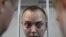 Ivan Safronov, a former journalist who works as an aide to the head of Russia's space agency Roscosmos, detained on suspicion of treason stands inside a defendants' cage before a court hearing in Moscow, Russia, July 7, 2020.