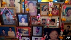 Portraits of victims from the Asian tsunami are displayed during a memorial service, Friday, Dec. 26, 2014 in Phang Nga, Ban Nam Khem province, Thailand.