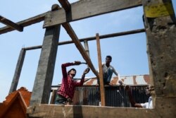 Villagers repair their house damaged by Cyclone Amphan in Satkhira, Bangladesh, on May 22, 2020.