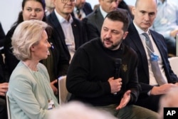 FILE - President of the European Commission Ursula von der Leyen, left, speaks with Ukraine's President Volodymyr Zelenskyy at the WEF, in Davos, Switzerland, January 16, 2024