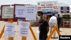 Notices about the shortage of Covishield, a coronavirus vaccine manufactured by Serum Institute of India, are seen outside a COVID-19 vaccination center in Mumbai, India, April 20, 2021. 