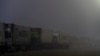 Trucks carrying vital humanitarian aid line up on the main road to the Rafah crossing amid harsh weather conditions. On the other side of the border, officials say as many as 14,000 Palestinians, including 2,500 children, require urgent medical evacuation. Rafah, Egypt, Feb. 4, 2025.