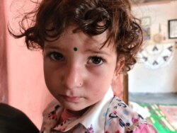 Zaineb, 3, cries from hunger, in Istanbul, May 20, 2020. (VOA/Heather Murdock)