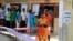A Sri Lankan ethnic Tamil couple leaves after casting their vote as others line up to vote at a polling station during the northern provincial council election in Jaffna, Sept. 21, 2013.