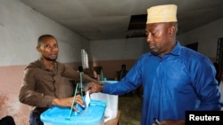 FILE — A voter casting his ballot at a polling centre during the Presidential election in Moroni, Comoros January 14, 2024.